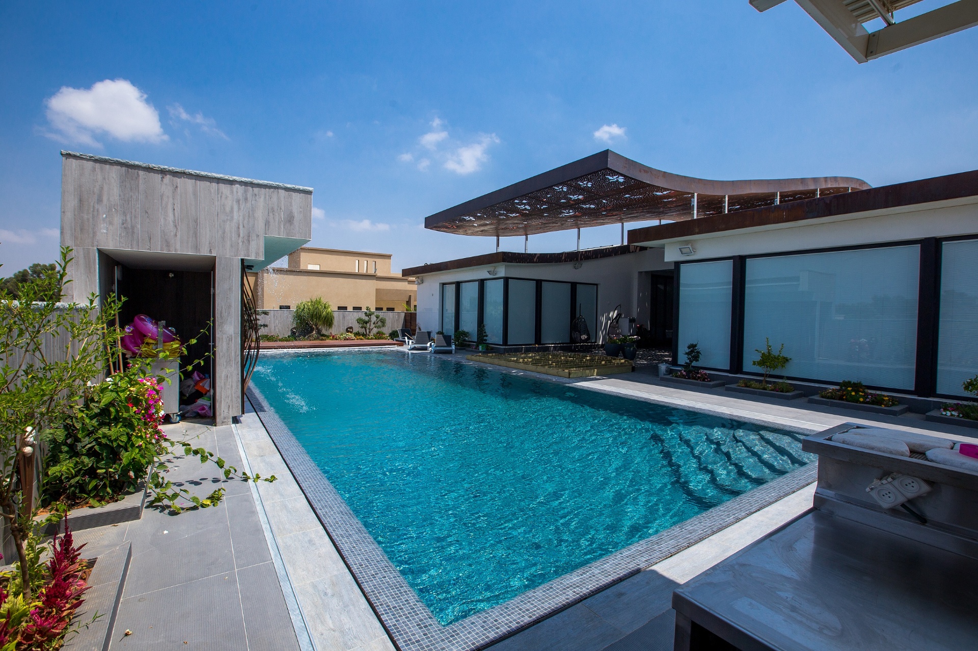 Luxury pool with mosaic tiling and architectural surround