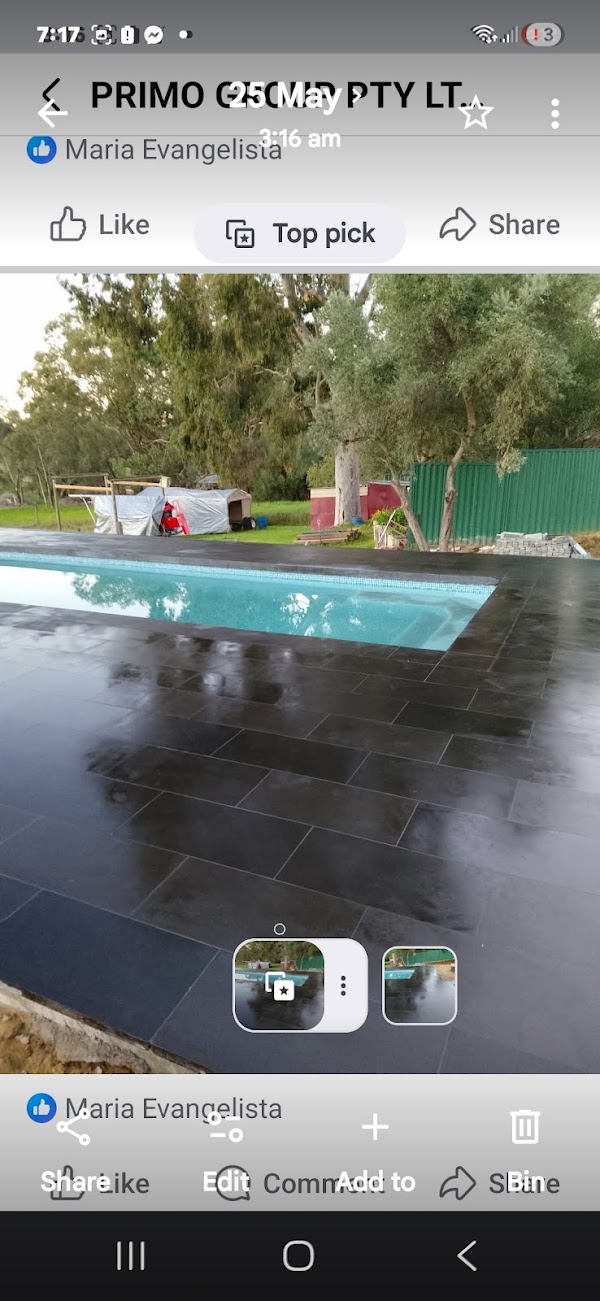 Concrete pool with new dark stone coping and paving