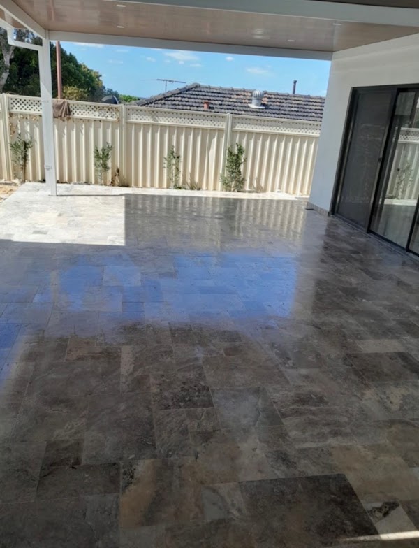 Travertine paved alfresco area alongside pool renovation