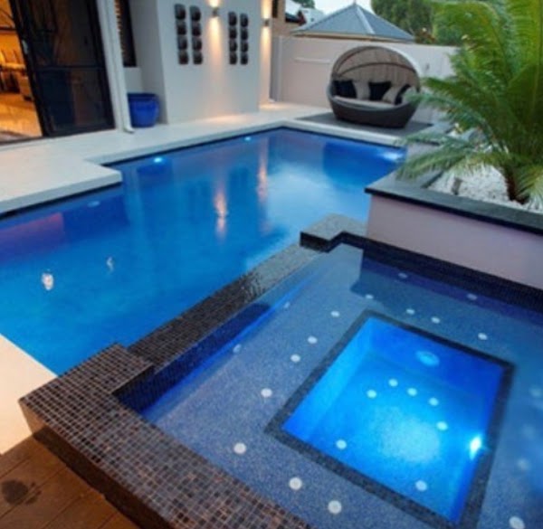 Modern pool and spa with mosaic tiles and feature lighting
