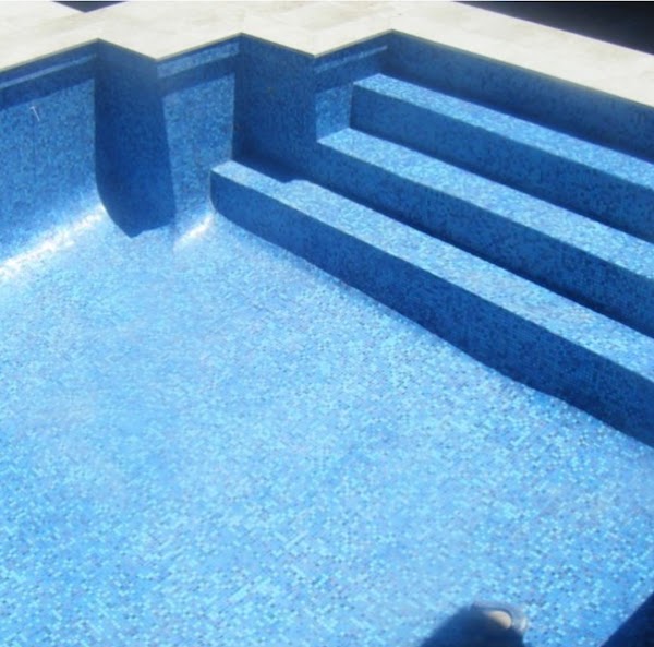Renovated pool steps and interior with blue mosaic tiling