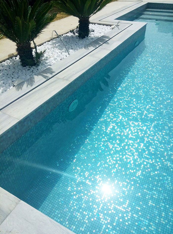 Pool with grey pearl mosaic tiles and marble coping