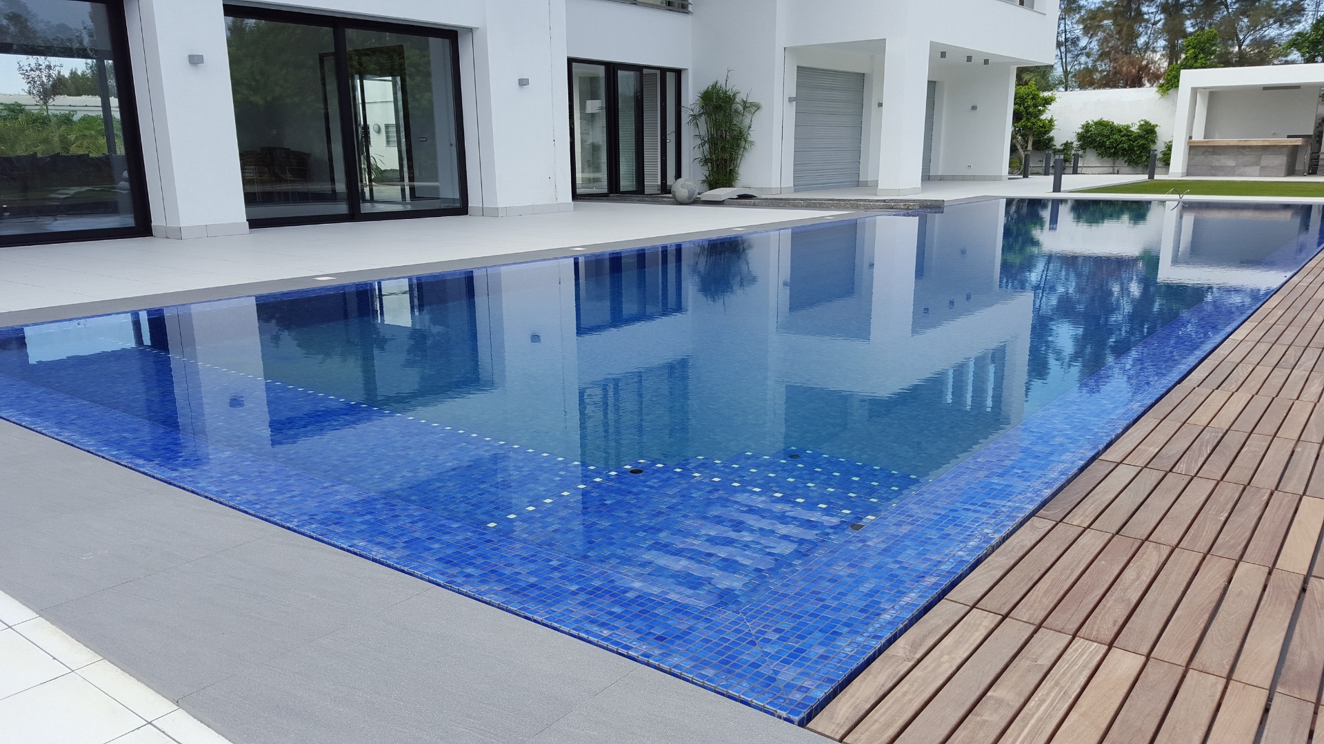 Modern villa pool with deep blue mosaic finish